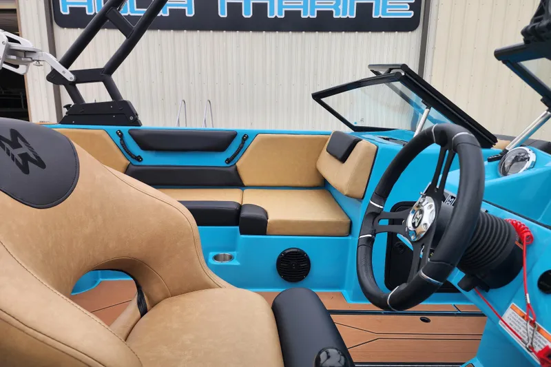 Slide: The Image of 2026 Heyday WT-2DC boat interior with tan and blue seating, steering wheel, and dashboard. - 3