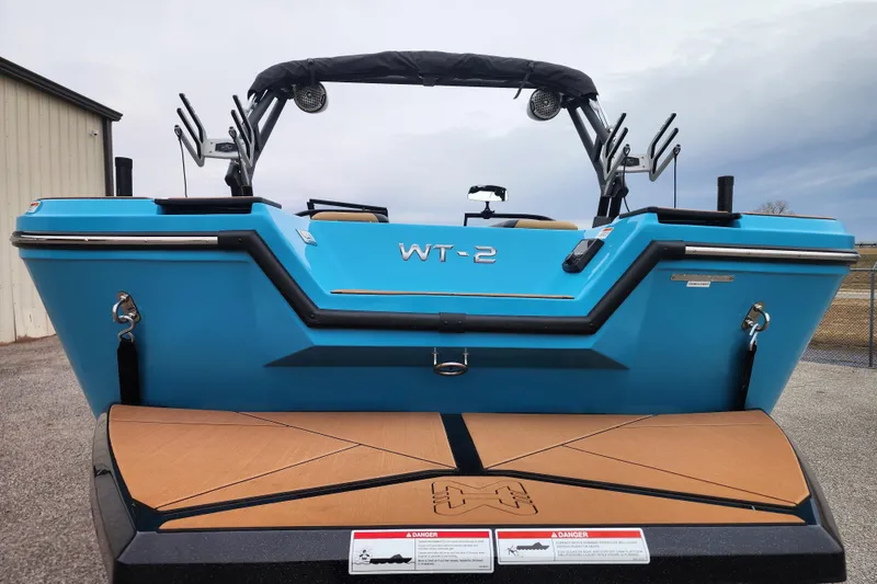 Slide: The Image of 2026 Heyday WT-2DC boat, blue exterior, rear view, parked outdoors. - 6