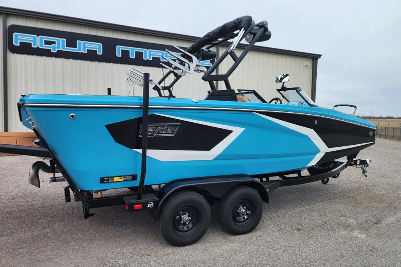 Slide: The Image of 2026 Heyday WT-2DC boat in vibrant blue and black design on a trailer. - 7