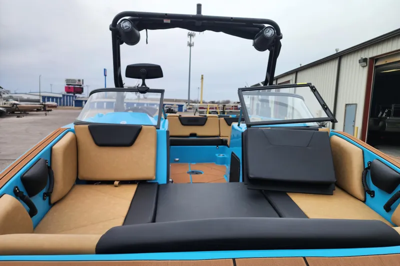 Slide: The Image of 2026 Heyday WT-2DC boat interior with tan and black seating, docked at a marina. - 4