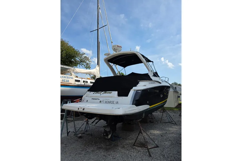 Slide: The Image of 2010 Regal 3360 Window Express boat on stands, outdoor storage setting. - 2