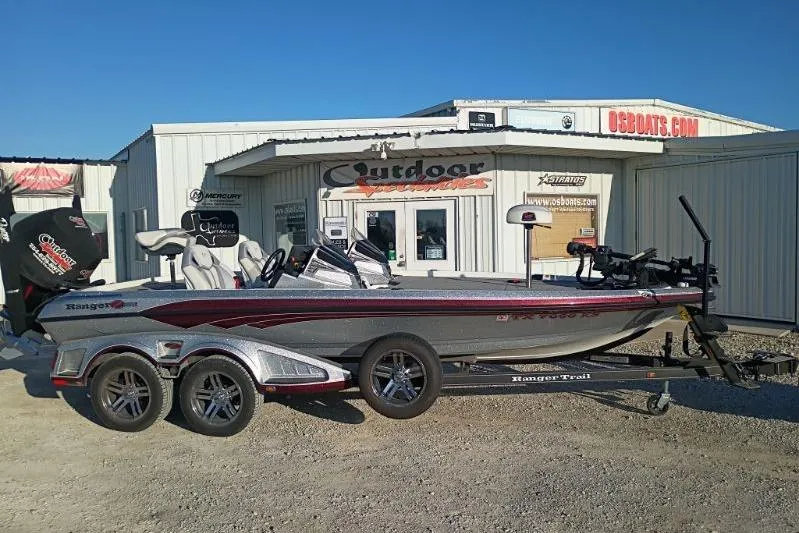 The Image of 2023 Ranger Z520R boat on trailer outside dealership, sunny day. - 1