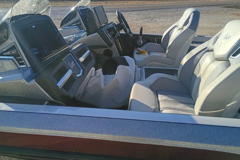 Slide: The Image of 2023 Ranger Z520R boat interior with modern dashboard and comfortable seating. - 10