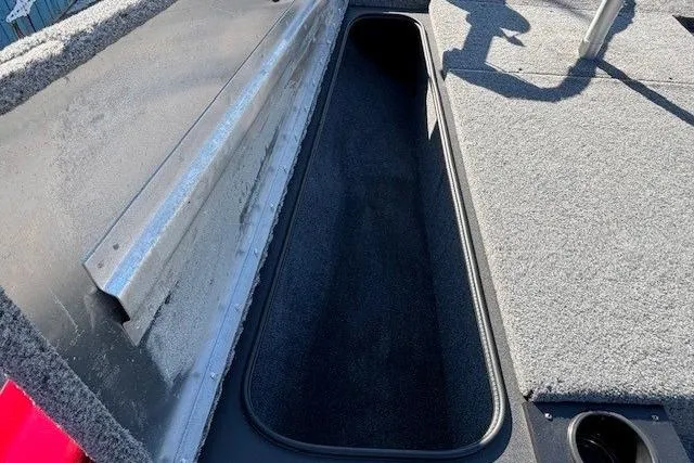 Slide: The Image of 2025 Tracker Pro Team 190 boat storage compartment with carpeted interior. - 10