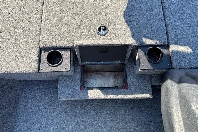 Slide: The Image of Interior of 2025 Tracker Pro Team 190 boat with storage compartment and cup holders. - 12