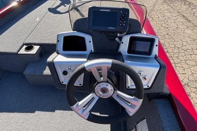 Slide: The Image of 2025 Tracker Pro Team 190 boat dashboard with steering wheel and navigation system. - 15