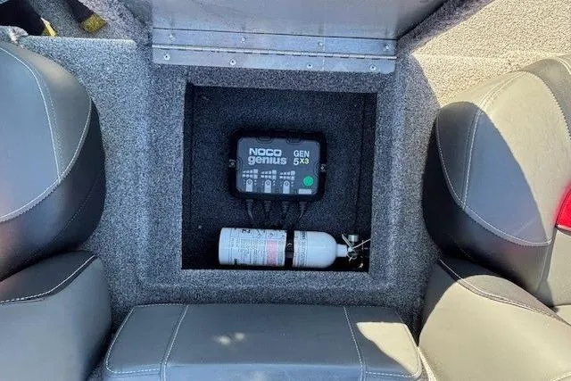 Slide: The Image of 2025 Tracker Pro Team 190 boat storage with NOCO Genius GEN5X3 charger and fire extinguisher. - 18