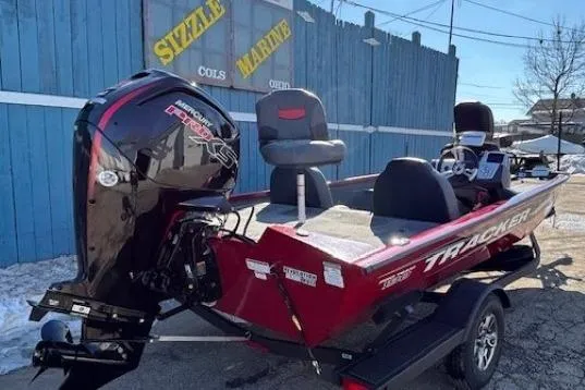 Slide: The Image of 2025 Tracker Pro Team 190 boat with powerful outboard motor, parked at Sizzle Marine dealership. - 2