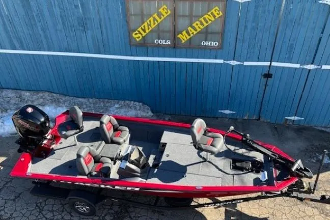 Slide: The Image of 2025 Tracker Pro Team 190 boat, red and gray, parked outside Sizzle Marine, Ohio. - 4