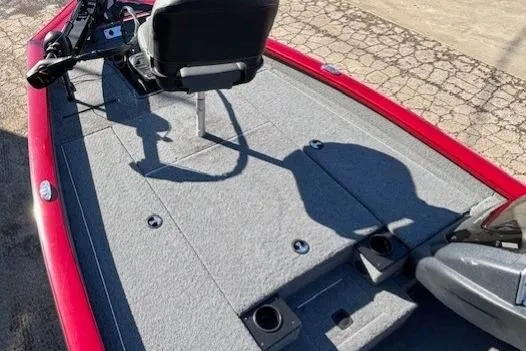 Slide: The Image of 2025 Tracker Pro Team 190 boat deck with seating and controls, featuring a red exterior. - 6