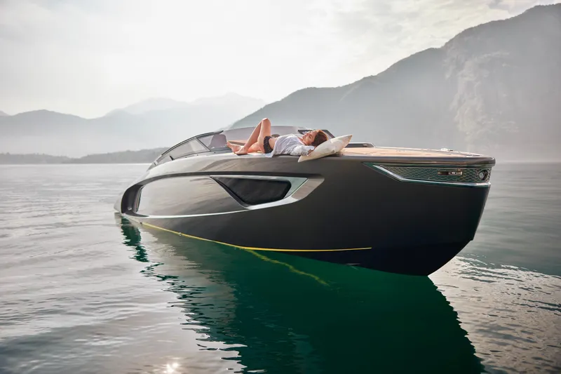 Slide: The Image of 2026 Flynt Yachts Centura 32 on serene water, person relaxing on deck. - 12