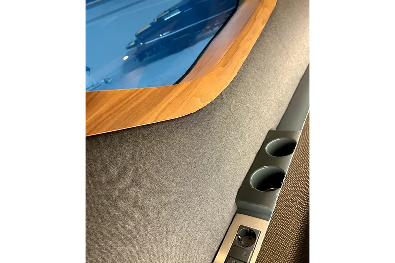 Slide: The Image of Interior detail of 2026 Flynt Yachts Centura 32, featuring wood trim and cup holders. - 19