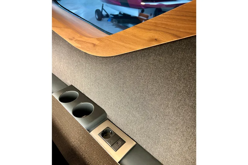 Slide: The Image of Interior detail of Flynt Yachts Centura 32, 2026 model, featuring cup holders and wood trim. - 21