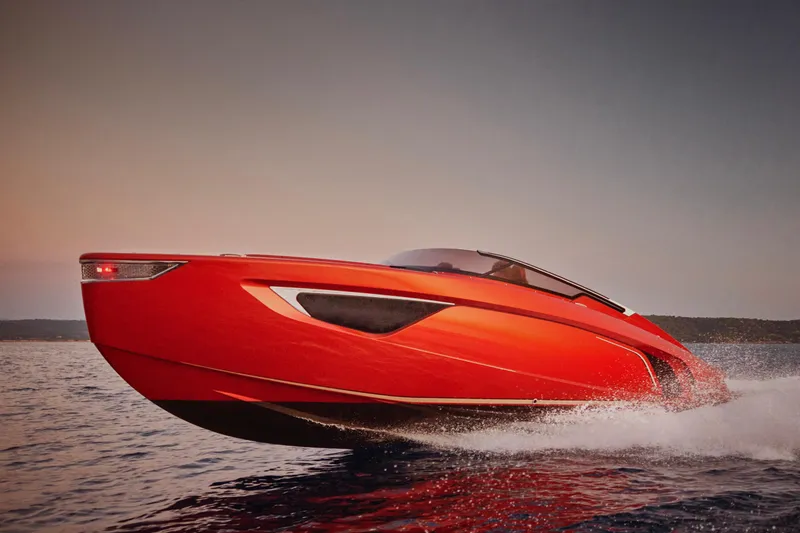 Slide: The Image of 2026 Flynt Yachts Centura 32, sleek red design, cruising on open water at sunset. - 5