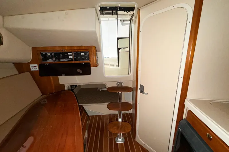 Slide: The Image of Interior of 2007 Pursuit OS 335 Offshore boat with wooden steps and control panel. - 15