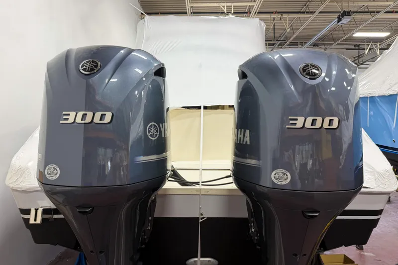 Slide: The Image of 2007 Pursuit OS 335 Offshore with twin Yamaha 300 outboard engines in a garage setting. - 18