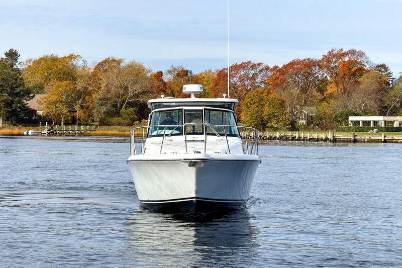 Slide: The Image of 2007 Pursuit OS 335 Offshore boat on calm water with autumn trees in background. - 2