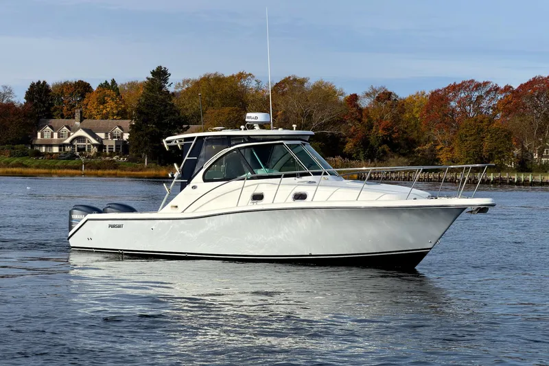Slide: The Image of 2007 Pursuit OS 335 Offshore boat on calm water with autumn trees in the background. - 22