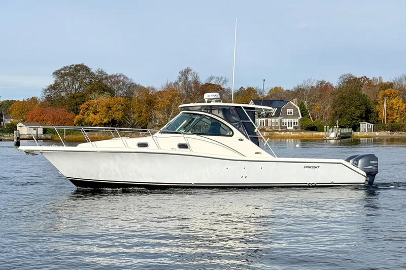 Slide: The Image of 2007 Pursuit OS 335 Offshore boat on calm water with autumn trees in the background. - 3
