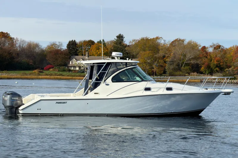 Slide: The Image of 2007 Pursuit OS 335 Offshore boat on calm water with autumn trees in background. - 4