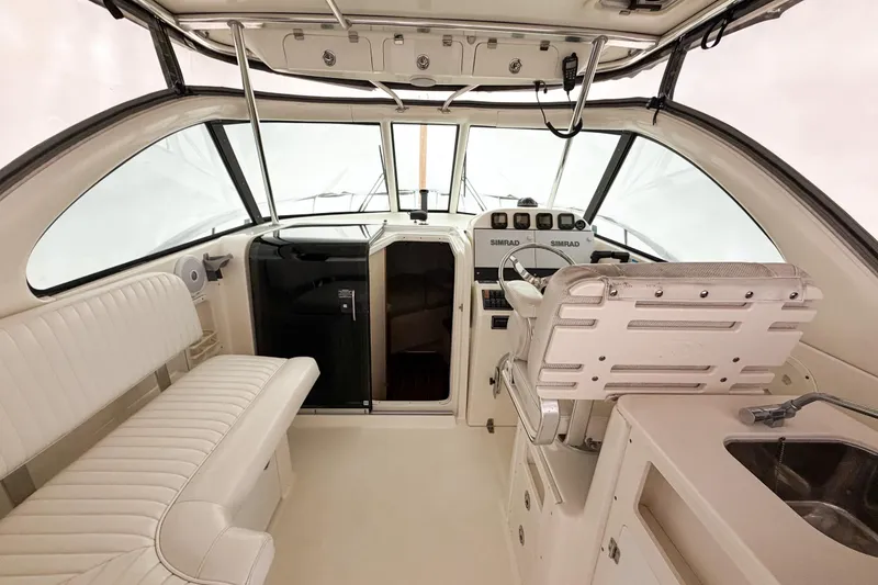 Slide: The Image of 2007 Pursuit OS 335 Offshore boat interior with helm, seating, and navigation equipment. - 7