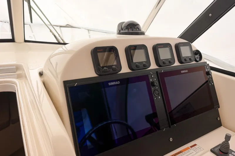 Slide: The Image of 2007 Pursuit OS 335 Offshore helm with Simrad displays and navigation instruments. - 9