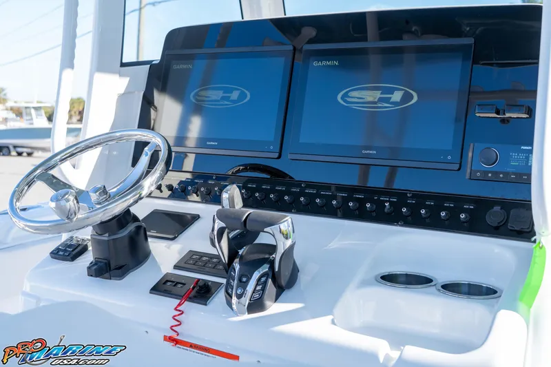 Slide: The Image of 2026 Sea Hunt Ultra 285 Coffin Box boat dashboard with Garmin displays and controls. - 17