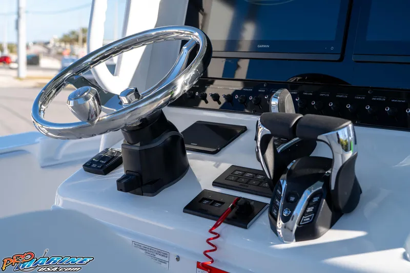 Slide: The Image of 2026 Sea Hunt Ultra 285 Coffin Box boat dashboard with steering wheel and controls. - 18