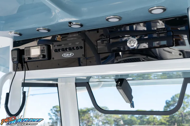 Slide: The Image of 2026 Sea Hunt Ultra 285 Coffin Box boat console with electronic controls and radio. - 19