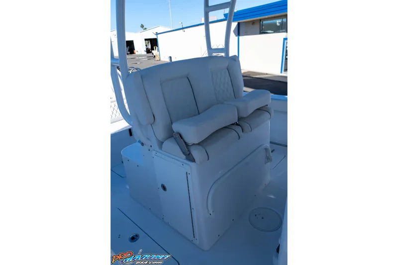 Slide: The Image of 2026 Sea Hunt Ultra 285 Coffin Box boat seating area with white cushioned seats. - 20