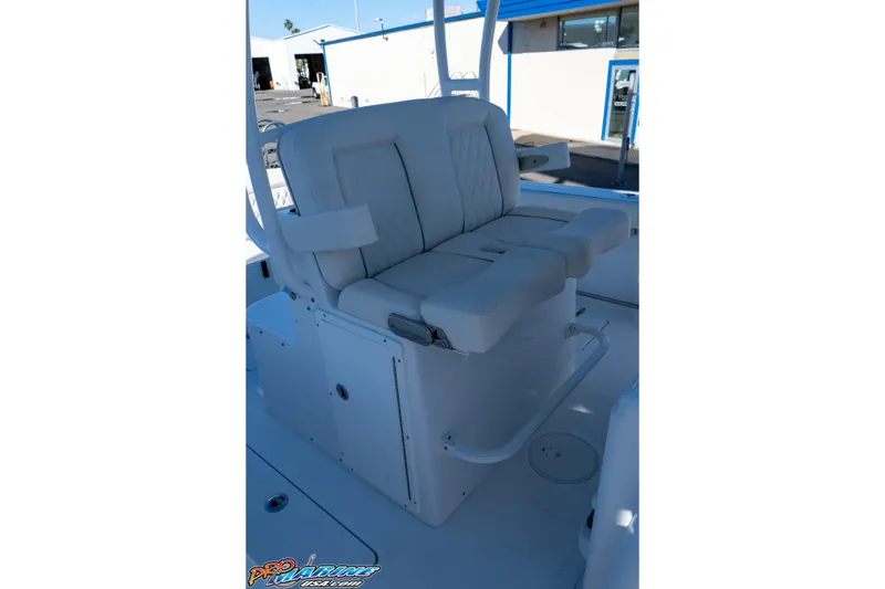 Slide: The Image of 2026 Sea Hunt Ultra 285 Coffin Box boat seat, white upholstery, outdoor setting. - 21