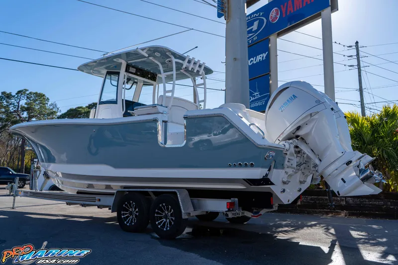 Slide: The Image of 2026 Sea Hunt Ultra 285 Coffin Box boat on trailer, displayed outdoors. - 5