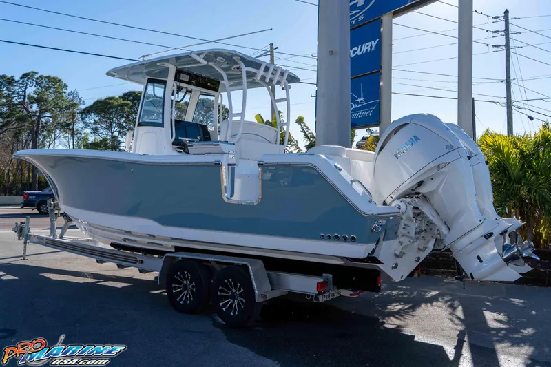 Slide: The Image of 2026 Sea Hunt Ultra 285 Coffin Box boat on trailer, featuring dual Yamaha engines. - 6