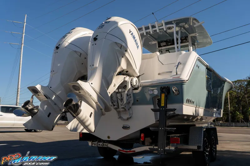 Slide: The Image of 2026 Sea Hunt Ultra 285 Coffin Box boat with dual Yamaha engines on a trailer. - 8