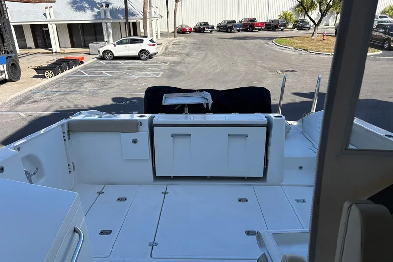 Slide: The Image of 2020 Pursuit DC 365 Dual Console boat storage compartment with ropes and equipment. - 14