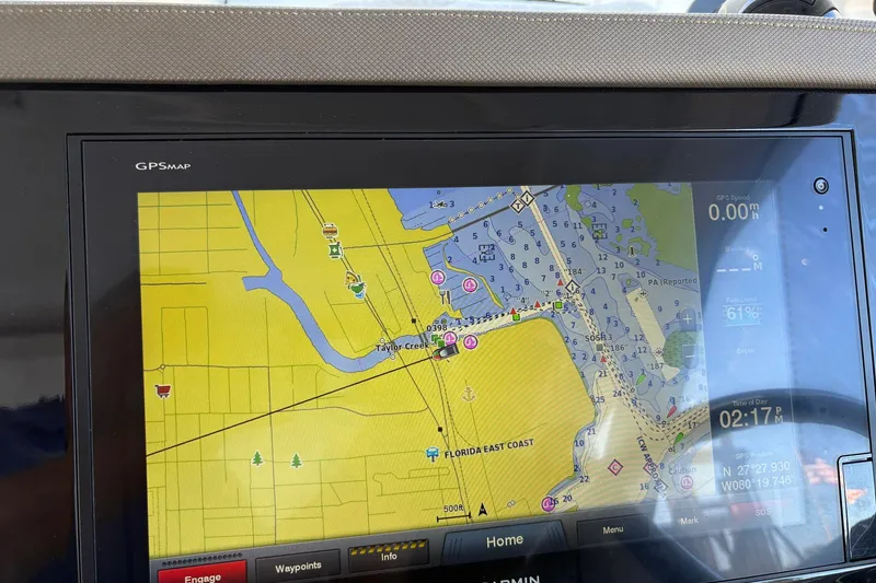 Slide: The Image of 2020 Pursuit DC 365 Dual Console boat on water near industrial buildings. - 4