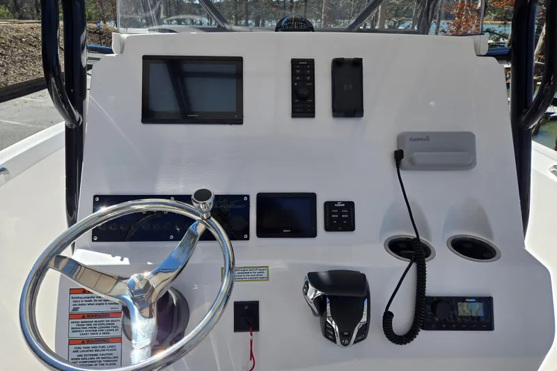 Slide: The Image of 2024 Aquasport 2100 Center Console dashboard with steering wheel and navigation equipment. - 15