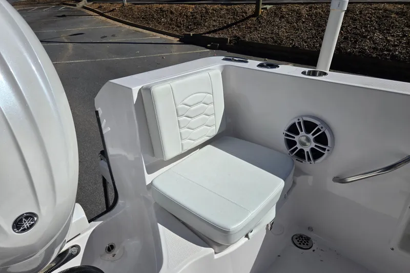 Slide: The Image of 2024 Aquasport 2100 Center Console boat seat with speaker and cup holder. - 16