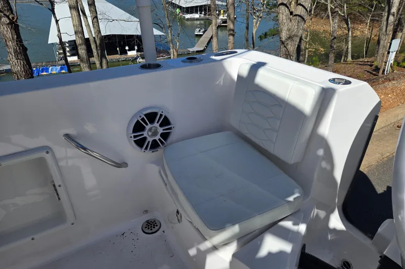 Slide: The Image of 2024 Aquasport 2100 Center Console boat interior with seating and speaker. - 17