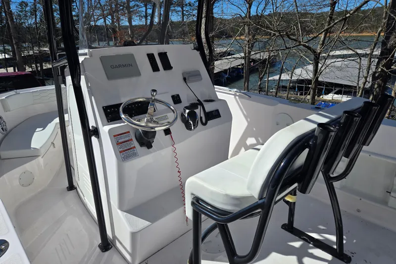 Slide: The Image of 2024 Aquasport 2100 Center Console boat interior with steering wheel and seating. - 19