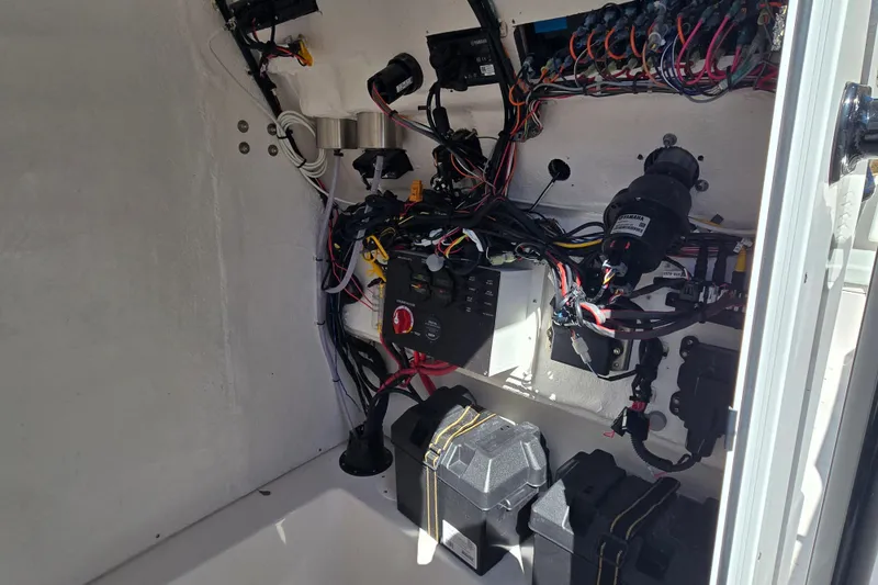 Slide: The Image of 2024 Aquasport 2100 Center Console electrical wiring and components inside compartment. - 20
