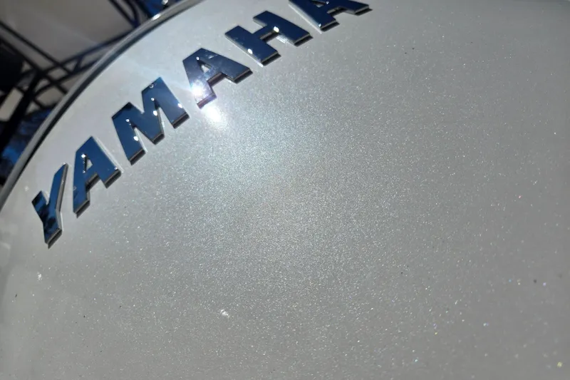 Slide: The Image of Close-up of Yamaha logo on 2024 Aquasport 2100 Center Console boat. - 24