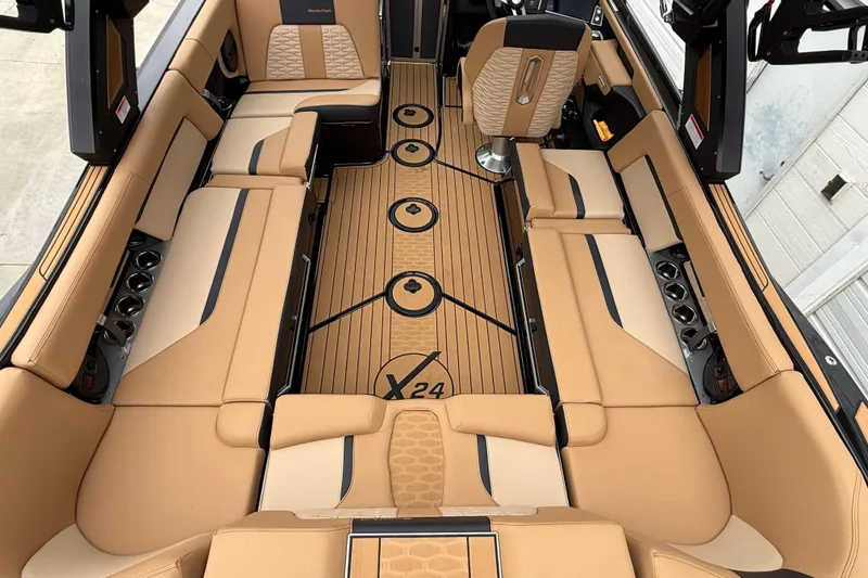 Slide: The Image of 2025 MasterCraft X24 boat interior with luxurious tan seating and sleek design. - 4