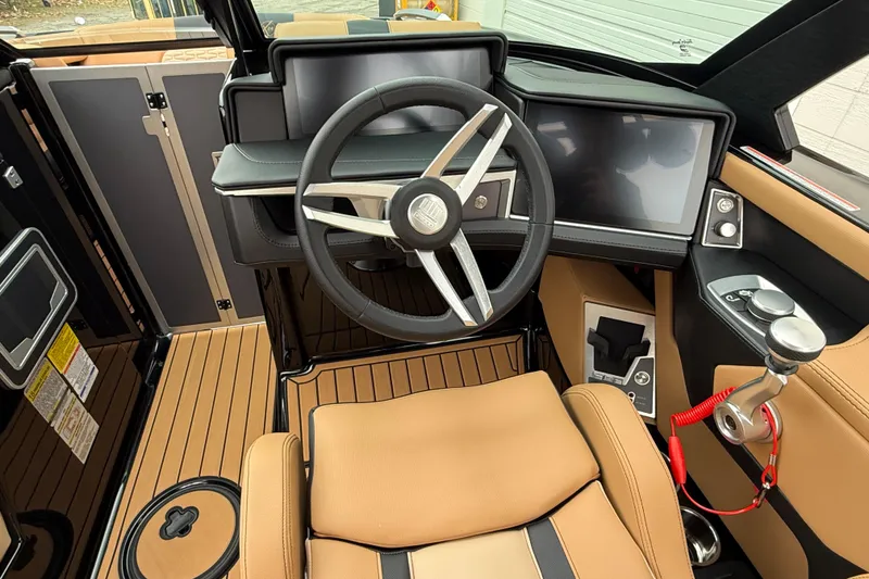 Slide: The Image of 2025 MasterCraft X24 boat cockpit with modern steering and digital displays. - 6