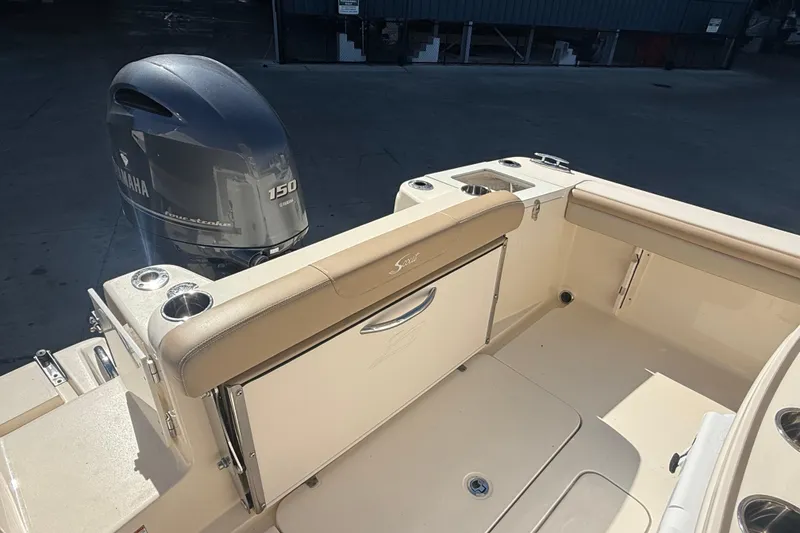 Slide: The Image of 2021 Scout 215 XSF boat with Yamaha 150 engine, featuring beige seating and cup holders. - 7