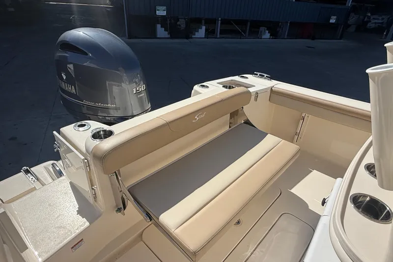 Slide: The Image of 2021 Scout 215 XSF boat with Yamaha 150 engine, featuring beige seating and cup holders. - 8