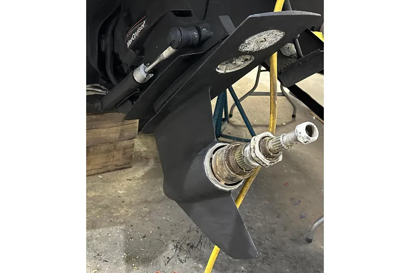 Slide: The Image of 2007 Sea Ray Sundancer 260 MerCruiser outdrive, detailed view in workshop setting. - 19