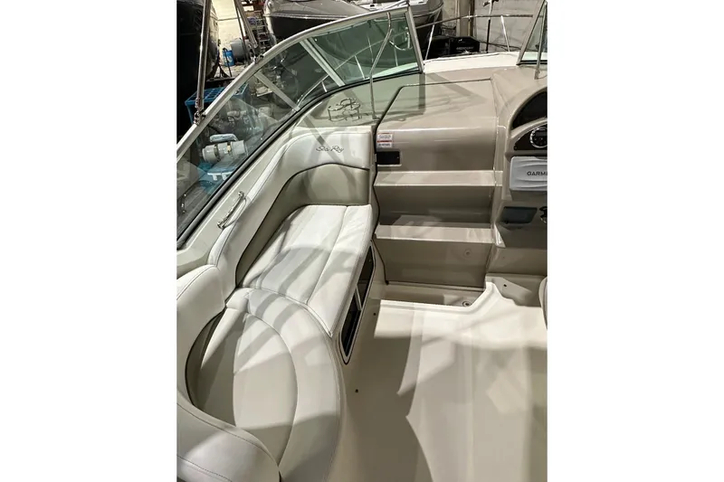 Slide: The Image of Interior of a 2007 Sea Ray Sundancer 260 boat, featuring beige seating and dashboard. - 7