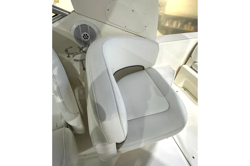 Slide: The Image of Luxurious seating on 2007 Sea Ray Sundancer 260 boat, featuring white upholstery and cup holders. - 9