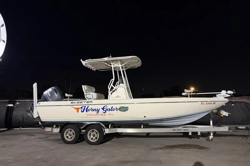 Slide: The Image of 2016 Skeeter SX2250 boat on trailer, labeled "Horny Gator," Panacea, FL, under clear blue sky. - 1